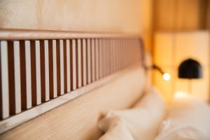 a close up of a wooden railing on a bed at Cala Ponte, a Tribute Portfolio Hotel in Polignano a Mare