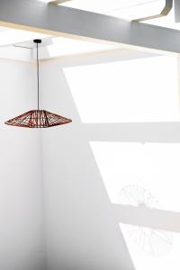 aendant light hanging from a ceiling in a room at Cala Ponte, a Tribute Portfolio Hotel in Polignano a Mare