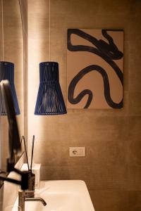 a bathroom with two blue lamps and a sink at Cala Ponte, a Tribute Portfolio Hotel in Polignano a Mare