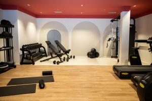 a gym with treadmills and exercise equipment in a room at Cala Ponte, a Tribute Portfolio Hotel in Polignano a Mare