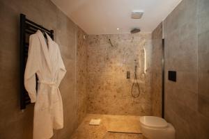 a bathroom with a shower and a toilet at Cala Ponte, a Tribute Portfolio Hotel in Polignano a Mare