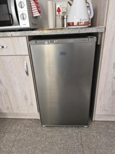 a silver dishwasher in a kitchen next to a counter at Mountain Rose Cottage in Bellville