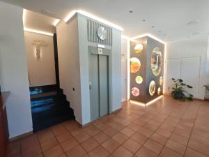 a hallway with a door and a tile floor at Hotel El Salt in Valderrobres