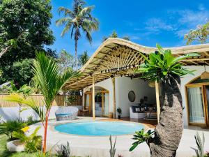a villa with a swimming pool and a pergola at You & Me Private Villa in Gili Islands +75 photos