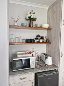 a kitchen with a microwave on a counter at Mountain Rose Cottage in Bellville
