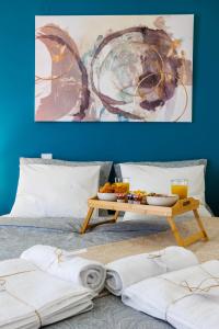 a table with a tray of food on a bed at Μi Casa Su Casa Apartment in Heraklio Town