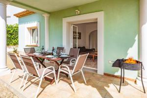 a dining room with a table and chairs at Villa Dalia by Villa Plus in Beniarbeig