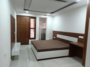 a bedroom with a bed in a room at Ishwar Bharti Apartments in Hisār