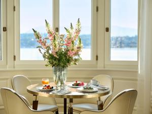 a table with chairs and a vase with flowers on it at The Woodward - Auberge Resorts Collection in Geneva