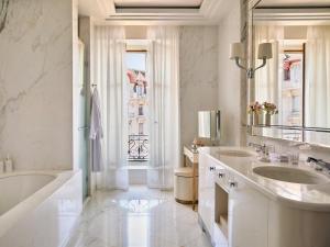 a bathroom with two sinks and a tub and a window at The Woodward - Auberge Resorts Collection in Geneva