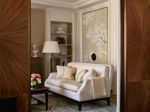a living room with a white couch with pillows at The Woodward - Auberge Resorts Collection in Geneva