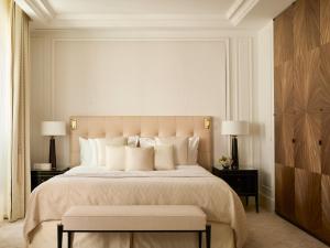 a bedroom with a large bed with white pillows at The Woodward - Auberge Resorts Collection in Geneva