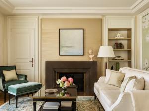 a living room with a couch and a fireplace at The Woodward - Auberge Resorts Collection in Geneva