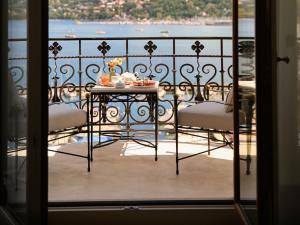 a table and chairs on a balcony with a view at The Woodward - Auberge Resorts Collection in Geneva