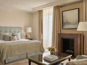 a bedroom with a bed and a fireplace at The Woodward - Auberge Resorts Collection in Geneva