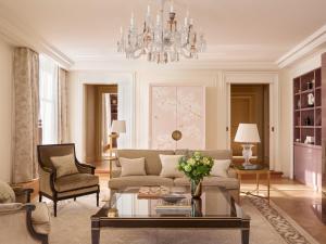 a living room with a couch and a chandelier at The Woodward - Auberge Resorts Collection in Geneva