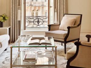 a living room with a glass coffee table and a chair at The Woodward - Auberge Resorts Collection in Geneva
