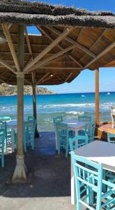 a group of tables and chairs on the beach at Sweet Home Kini in Kinion