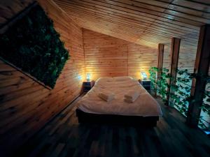 a bedroom with a bed in a wooden wall at One & Kos Resort in Costinesti +60 photos