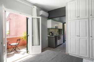 Ionian Sea View Studio at Barbati by Konnect في برباتي: مطبخ مع باب مفتوح على مطبخ مع طاولة