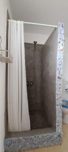 a shower with a shower curtain in a bathroom at Sweet Home Kini in Kinion +25 photos