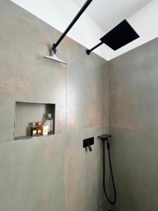 a bathroom with a shower with a ceiling fan at Villa Giulia in Sulzano