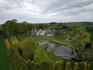 an aerial view of a house with a pond at Eden-Dom Wakacyjny z Domkiem Gościnnym in Trelleborg