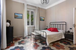 a bedroom with a bed with a red pillow on it at La casa di Licia in La Spezia