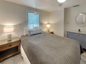 a bedroom with a bed and two lamps and a window at The CrabTrap at Flager Beach - Manor in Flagler Beach