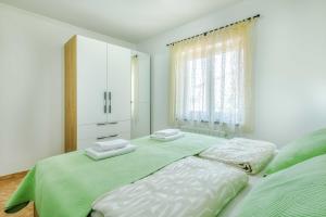 Postel nebo postele na pokoji v ubytování Apartments Rose