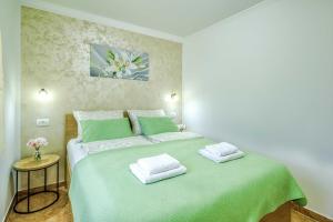 Postel nebo postele na pokoji v ubytování Apartments Rose