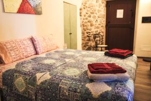 a bedroom with a bed with two towels on it at Agripodere il Falco - Tuscany Nature & Relax in Pontremoli