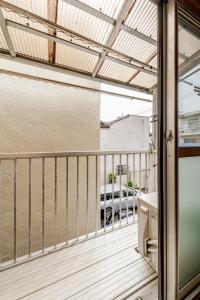 a balcony with a view of a parked car at Stay Like a Local Hiroshima Hiroshima Station Entire House 1-6 ppl in Hiroshima