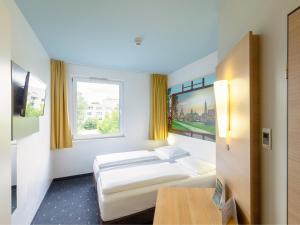 Postel nebo postele na pokoji v ubytování B&B Hotel Dresden-Messe