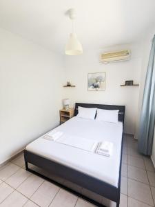 a bedroom with a white bed in a room at Mola Kaliva Seaview Retreat in Mola Kalyva