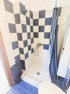 a bathroom with a black and white checkered shower at Mola Kaliva Seaview Retreat in Mola Kalyva +9 photos