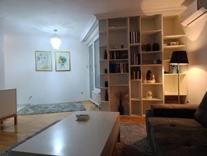 a living room with a couch and a coffee table at CityComfort Tuzla - City Center Free Private Parking in Tuzla
