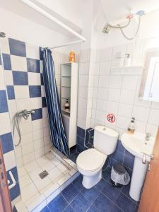 a bathroom with a toilet and a sink at Mola Kaliva Seaview Retreat in Mola Kalyva