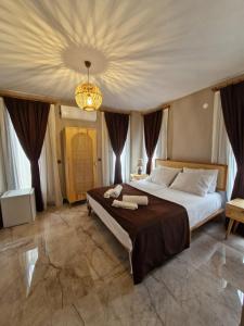 a bedroom with a large bed and a chandelier at Velder House Urla in Urla
