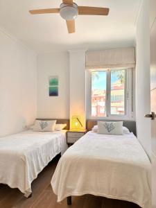 A bed or beds in a room at Anacasa Puerta del Palmar AP2207