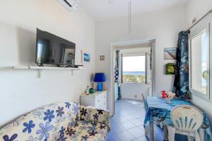 a living room with a couch and a table at Appartamenti Costasud in Capoliveri