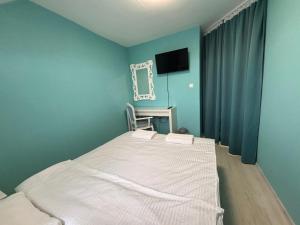 A bed or beds in a room at Sozopol Romance Apartments