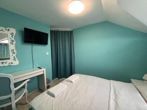A bed or beds in a room at Sozopol Romance Apartments