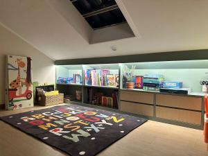 a room with a library with a rug on the floor at Amarillo 2 Lembang in Bongkar 2