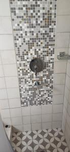 a bathroom with a shower with a tiled wall at LA VALENTINA casa de campo in Villa Cura Brochero +23 photos