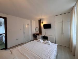A bed or beds in a room at Sozopol Romance Apartments