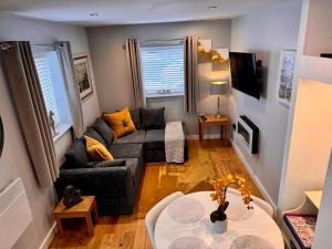 a living room with a couch and a table at Detached one bedroom house near to castle and cathedral in Lincoln