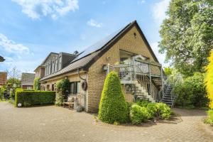 a brick house with a staircase on the side of it at Göckes Haus Und Garten Wiesenblick in Wettringen