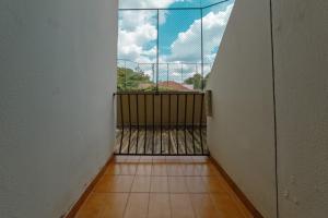 a room with a balcony with a large window at Conforto no Centro de Maringá MC11 in Maringá