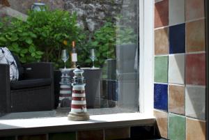 a window with a lighthouse sitting on a window sill at 54 On the Rocks- characterful coastal cottage in Anstruther +20 photos